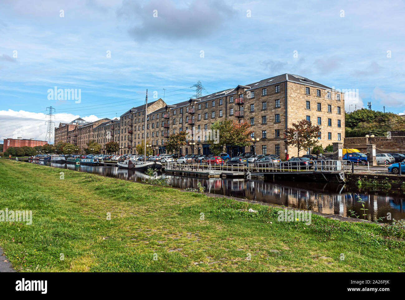 Old warehouses converted to flats at Speirs Wharf at the Glasgow branch of the Forth and Clyde Canal in Glasgow Scotland UK Stock Photo