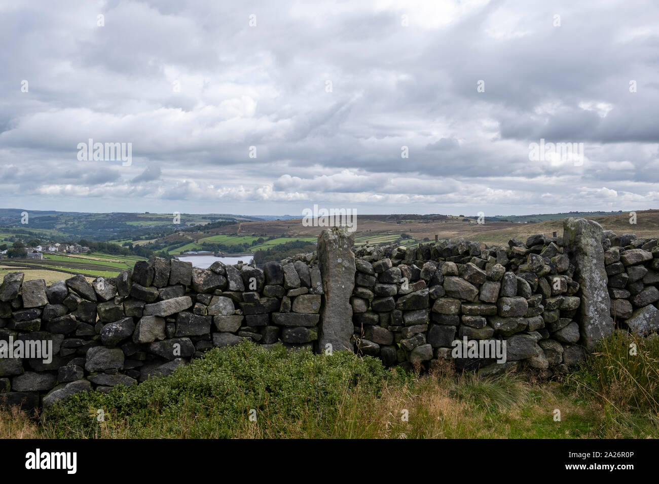 An example of a single width dry stone wall in the entrance to a field on a walking path near the Pennine Way in Stanbury, West Yorkshire Stock Photo