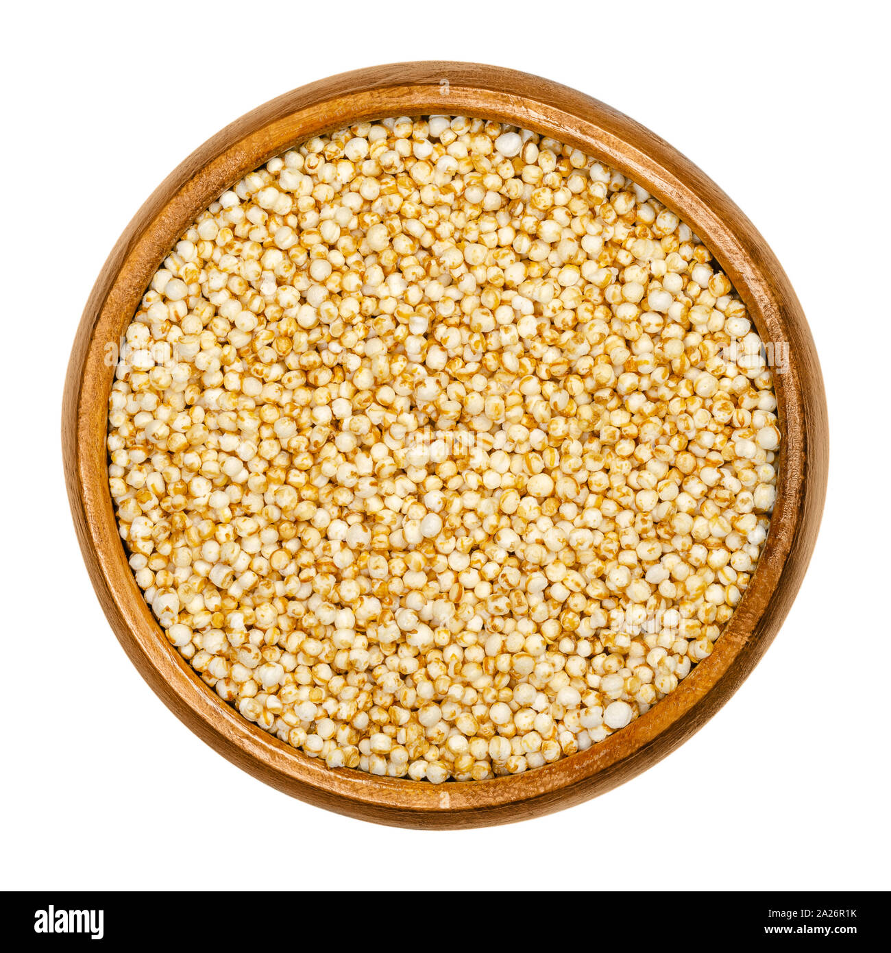 Puffed quinoa in wooden bowl. Popped seeds of Chenopodium quinoa, a pseudocereal, used like breakfast cereals and in the form of rice cakes. Stock Photo