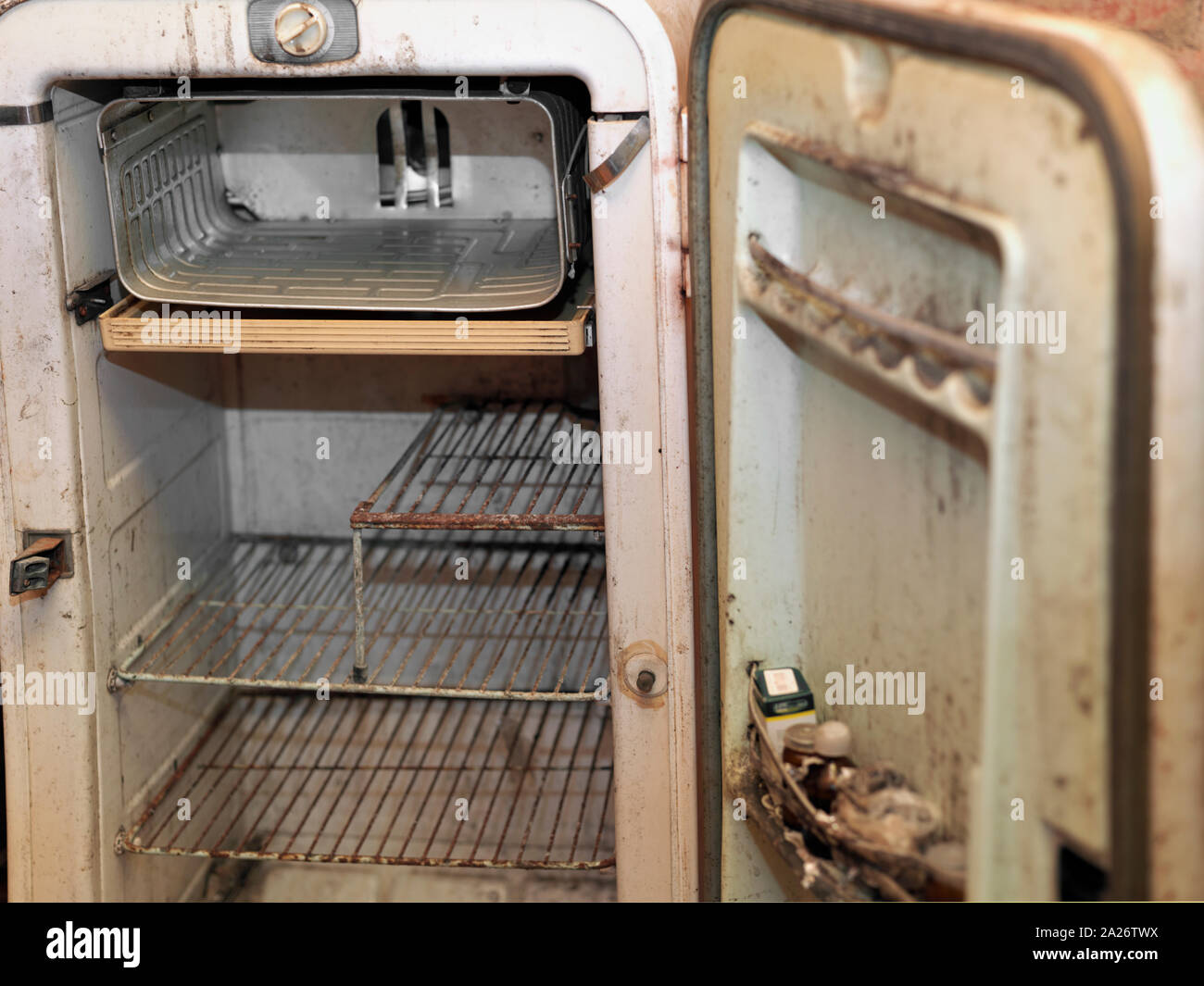 Abandoned rusty fridge with open door and no food inside, filtered image Stock Photo Alamy