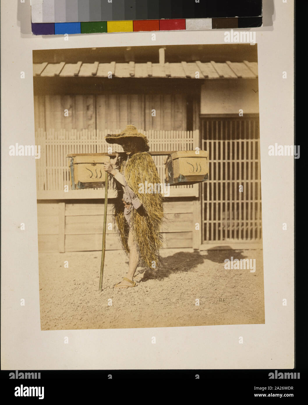 Porter wearing protective outer garments made of straw Stock Photo Alamy