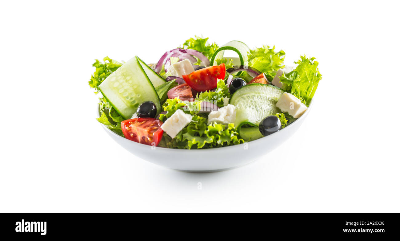 Salad with fresh vegetables olives tomatoes red onion greek cheese feta and olive oil isolated on white background Stock Photo