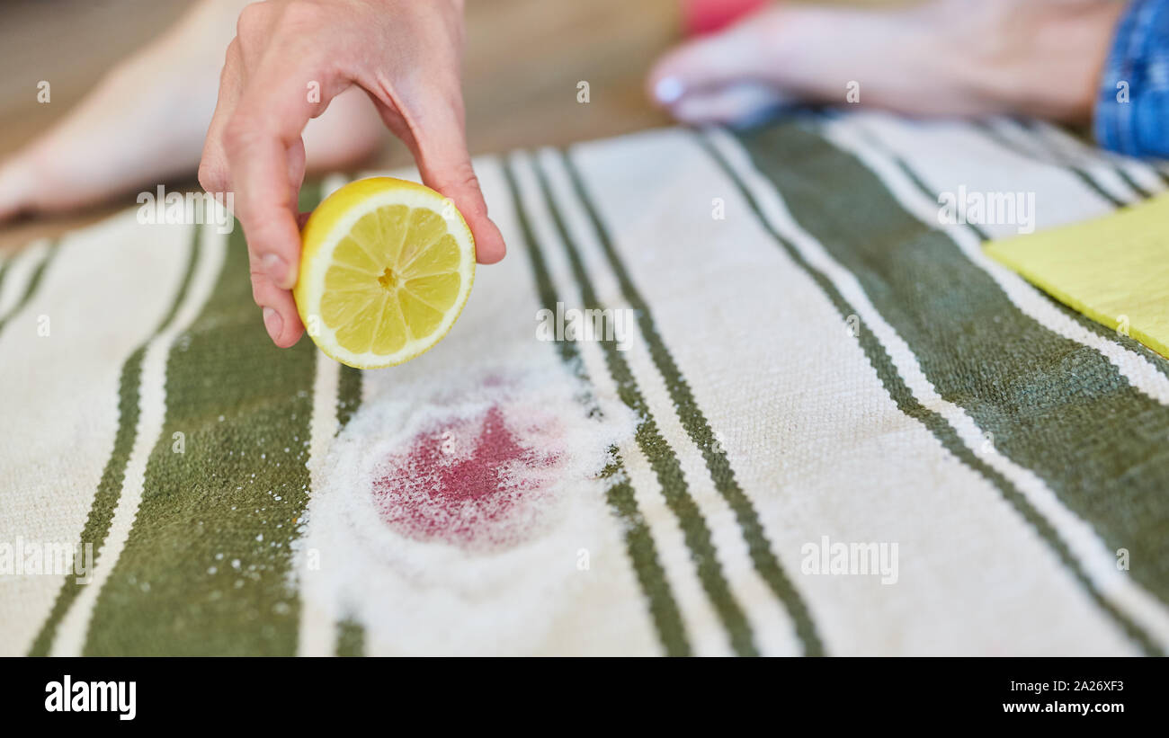 Lemon and salt as a home remedy for removing red wine stains on carpet Stock Photo