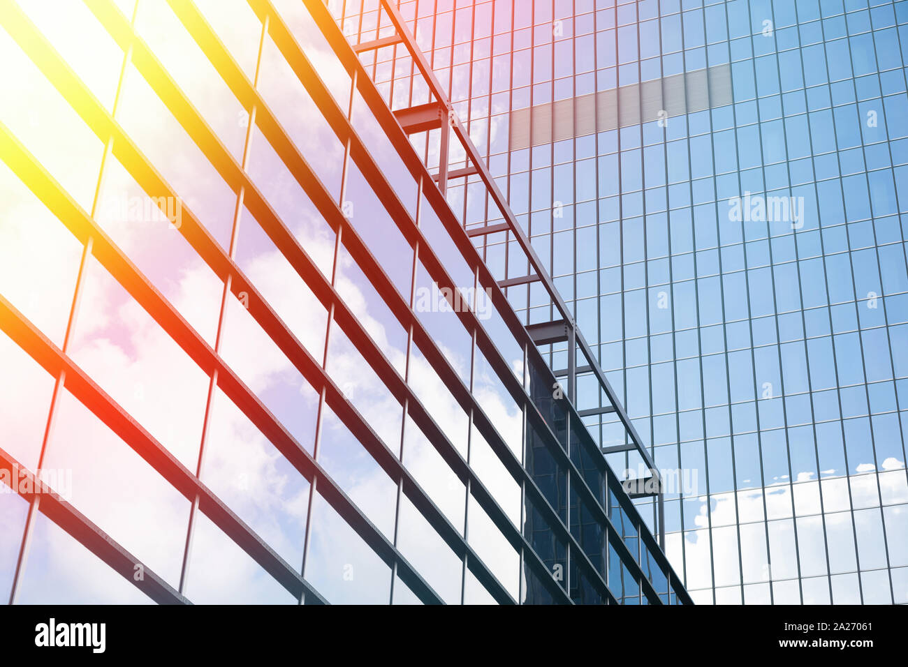 Tall glass building reflecting sky with white clouds Stock Photo - Alamy