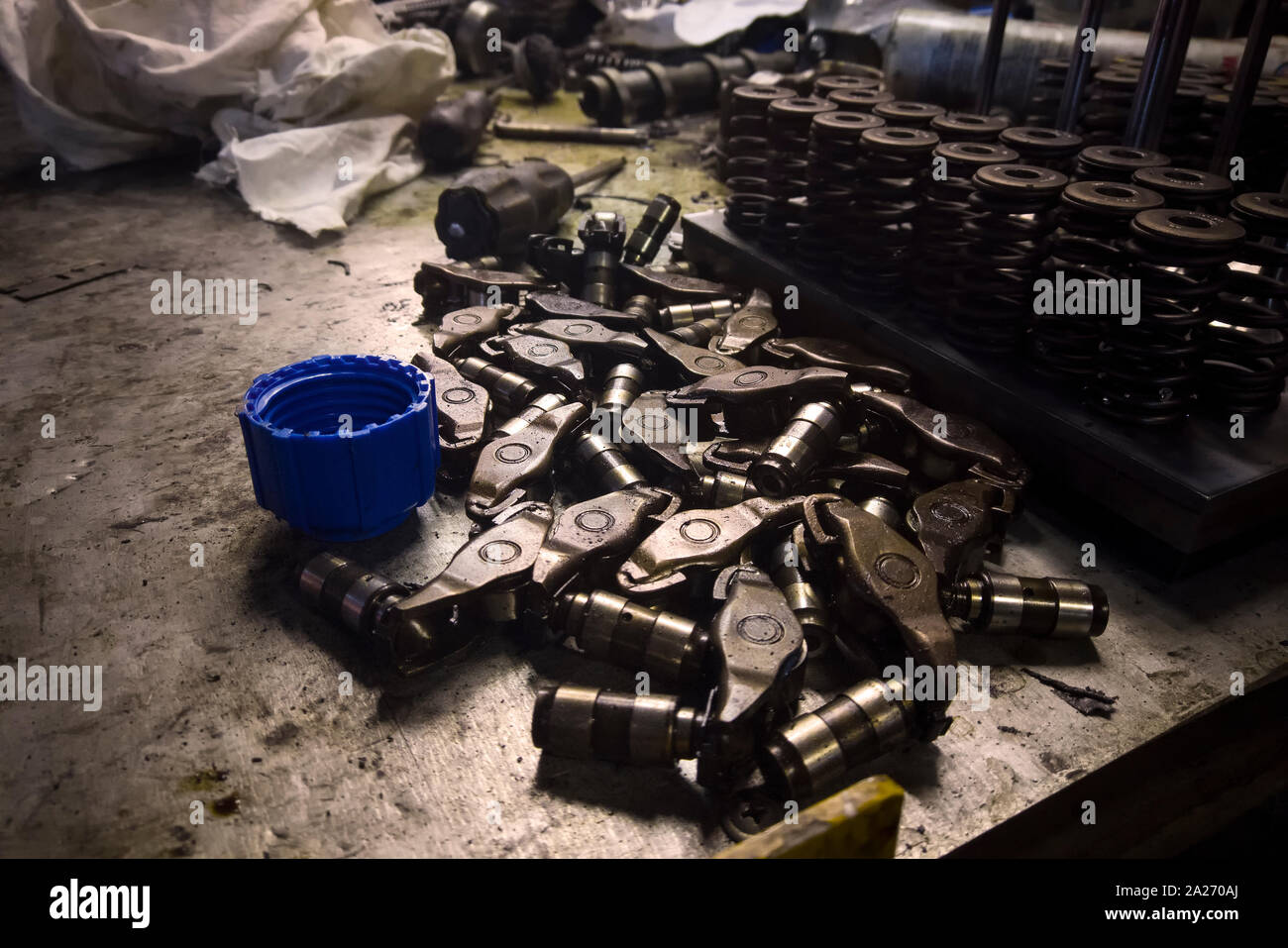 Cleaning the parts of disassembled engine with greasy rag, indoor close