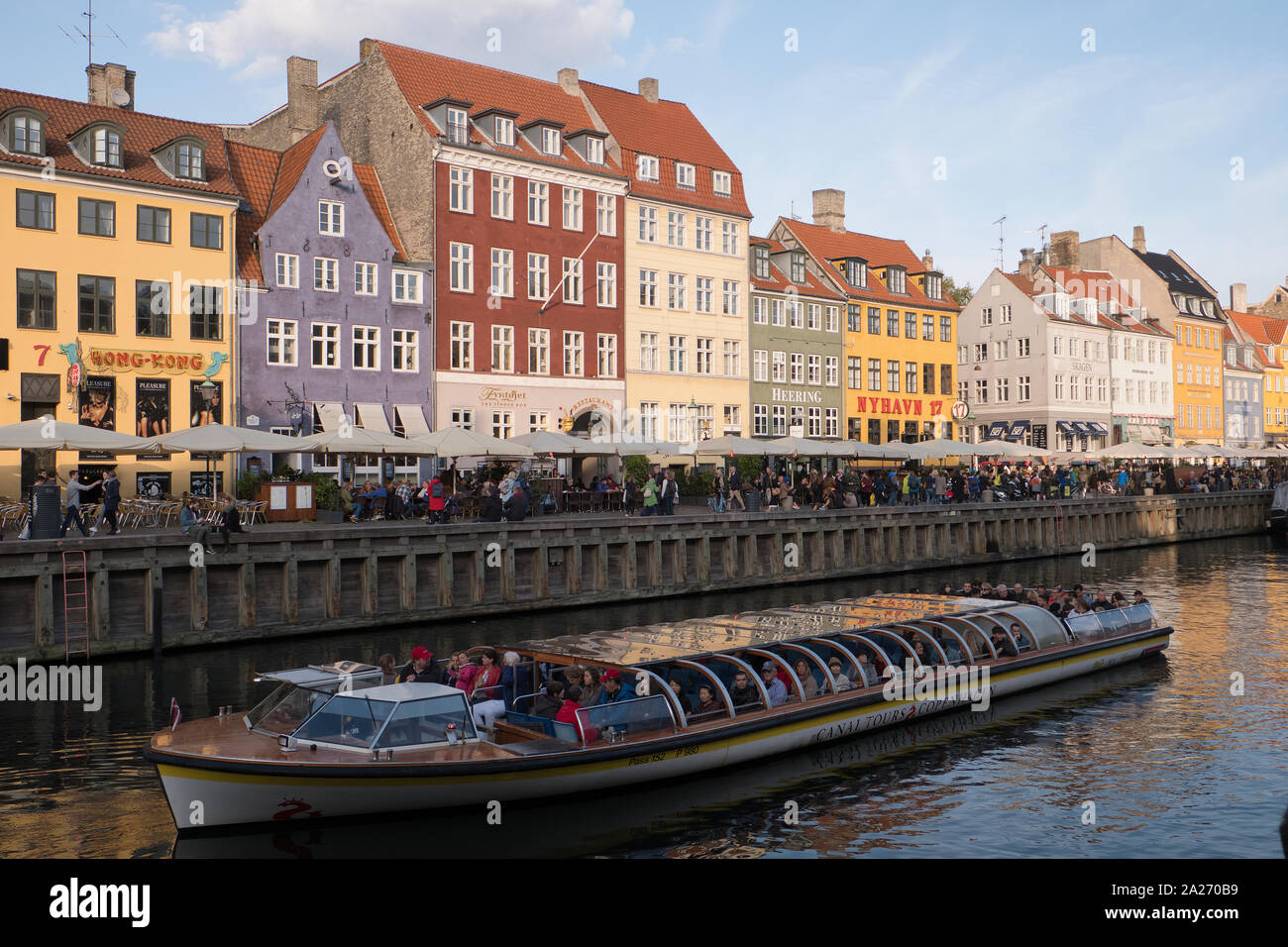 tourists on river boat in Nyhavn in Copenhagen on an autumn day, Denmark Stock Photo