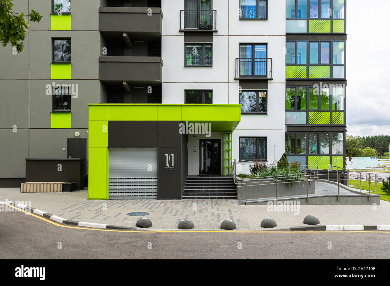 Entrance to dwelling building painted in green, white and grey Stock