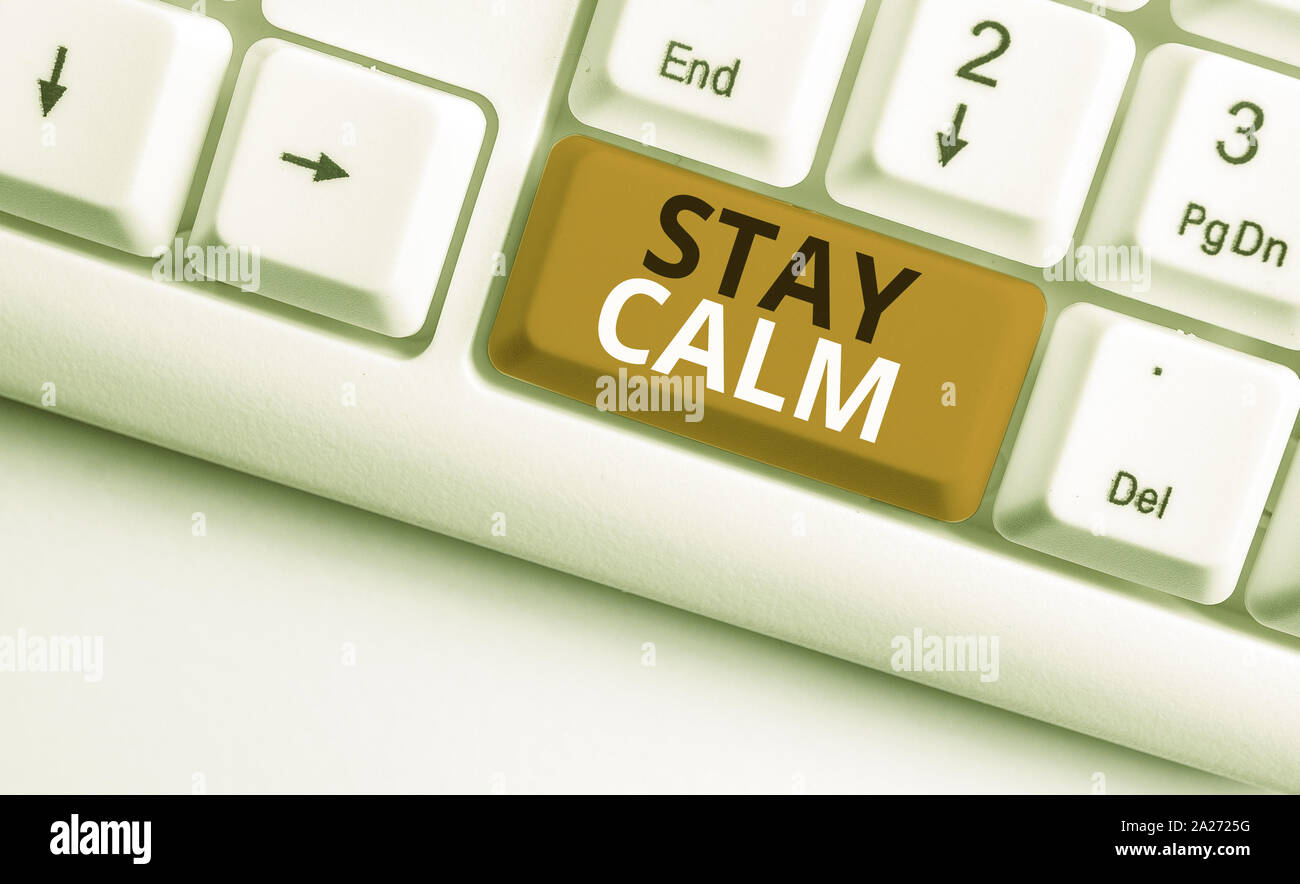 Writing note showing Stay Calm. Business concept for Maintain in a state of motion smoothly even under pressure White pc keyboard with note paper abov Stock Photo
