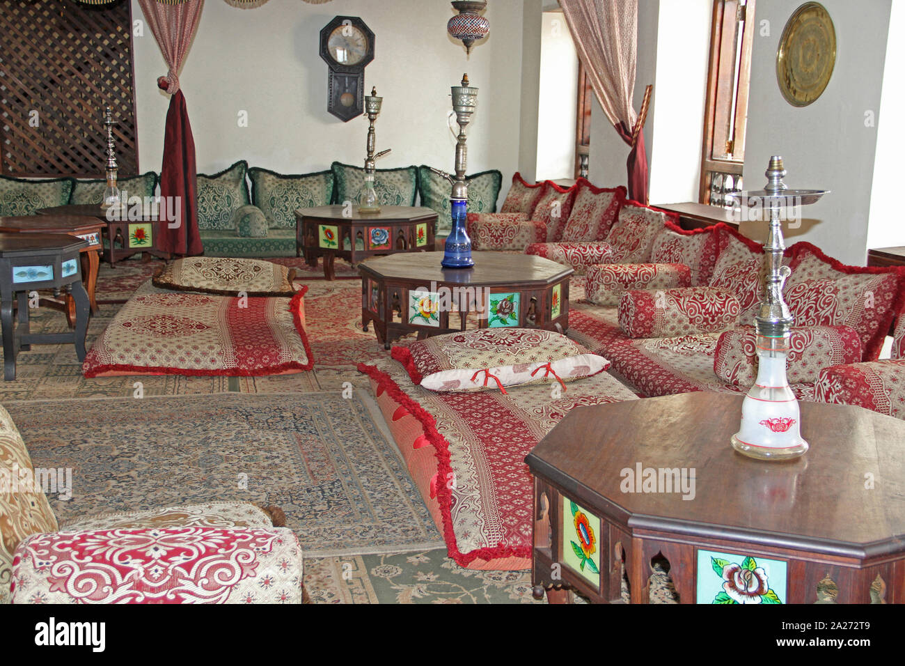 Couches and hookah pipes in a hotel lounge, Stone town, Zanzibar, Unguja Island, Tanzania. Stock Photo