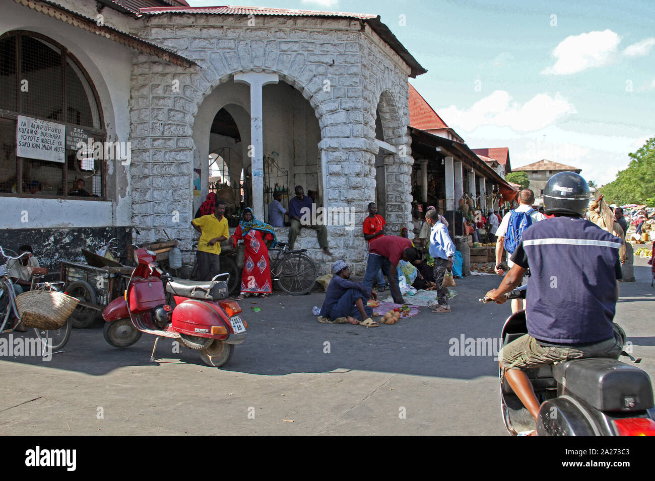 Tourists, motorists and vendors in open street, Stone Town, Zanzibar, Unguja Island, Tanzania. Stock Photo