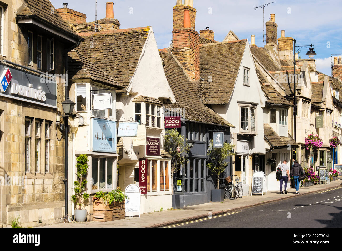 Small shops and cafes in quaint old buildings in pretty historic town centre. St Paul's Street Stamford Lincolnshire England UK Britain Stock Photo
