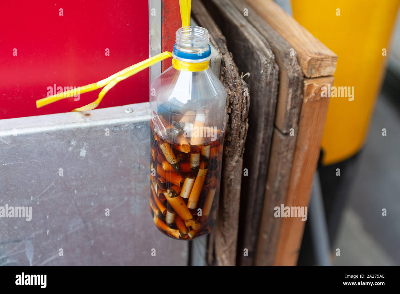 24.02.2019, Singapore, , Singapore - A plastic bottle in Chinatown serves as an ashtray for cigarette butts. 0SL190224D017CAROEX.JPG [MODEL RELEASE: N Stock Photo