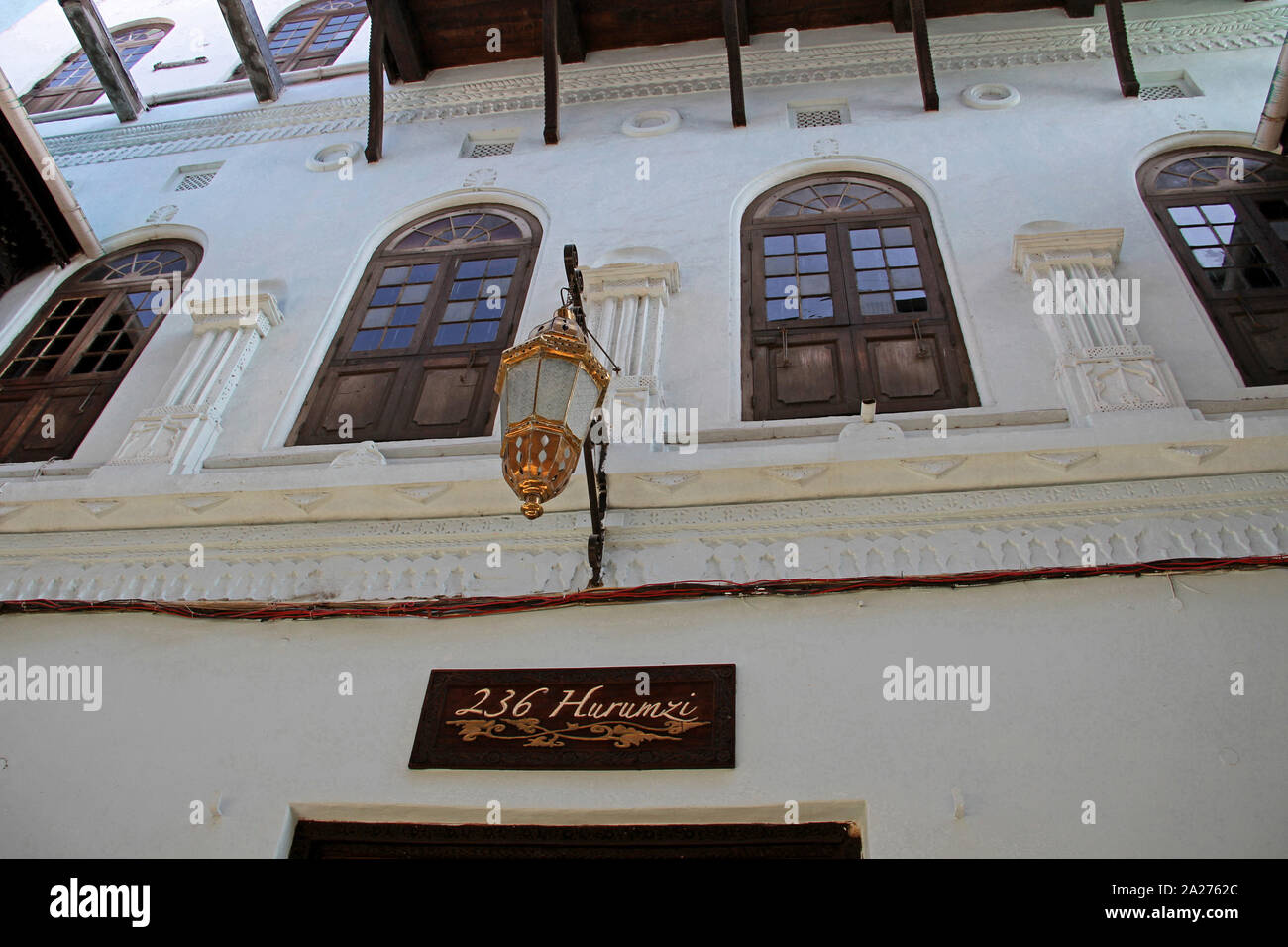 Metal street hanging light on wall outside Emerson on Hurumzi and the