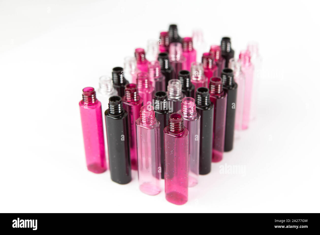group of small pink and fuchsia colored bottles side by side Stock Photo