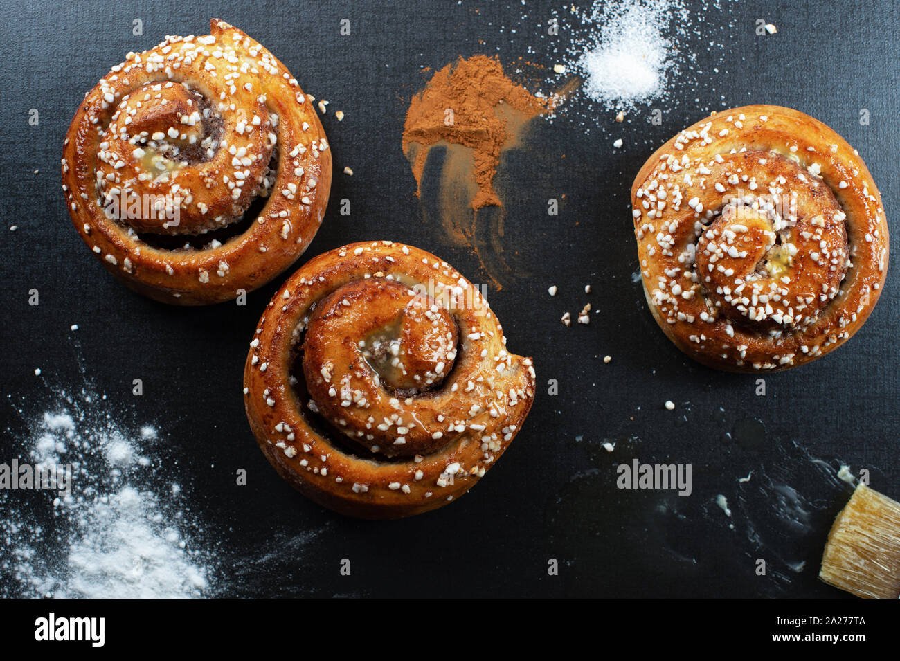 Freshly homemade cinnamon buns baked with butter. Pearl sugar on top. Both vertical and horizontal. Turn left for vertical Stock Photo