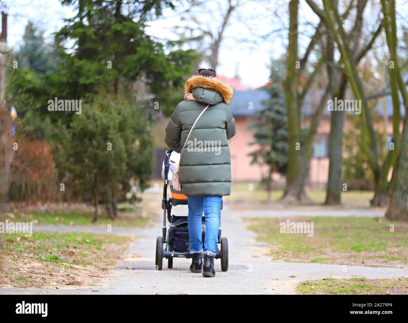 mother with a baby stroller on a walk Stock Photo