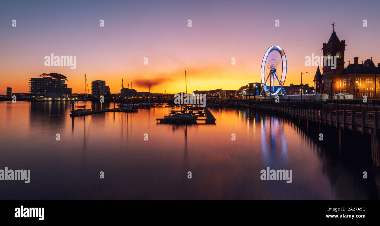 Big Wheel, Pier head building and ferris building located in Mermaid Quay of Cardiff Bay - Cardiff, Wales, United Kingdom at Night Stock Photo
