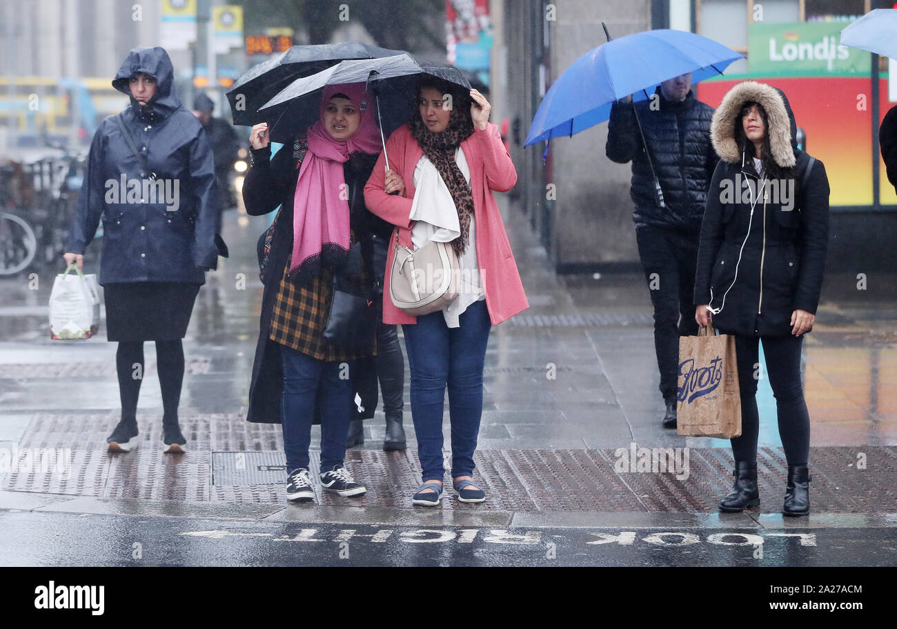 People out in the wind and rain in Dublin city centre, Ireland Stock