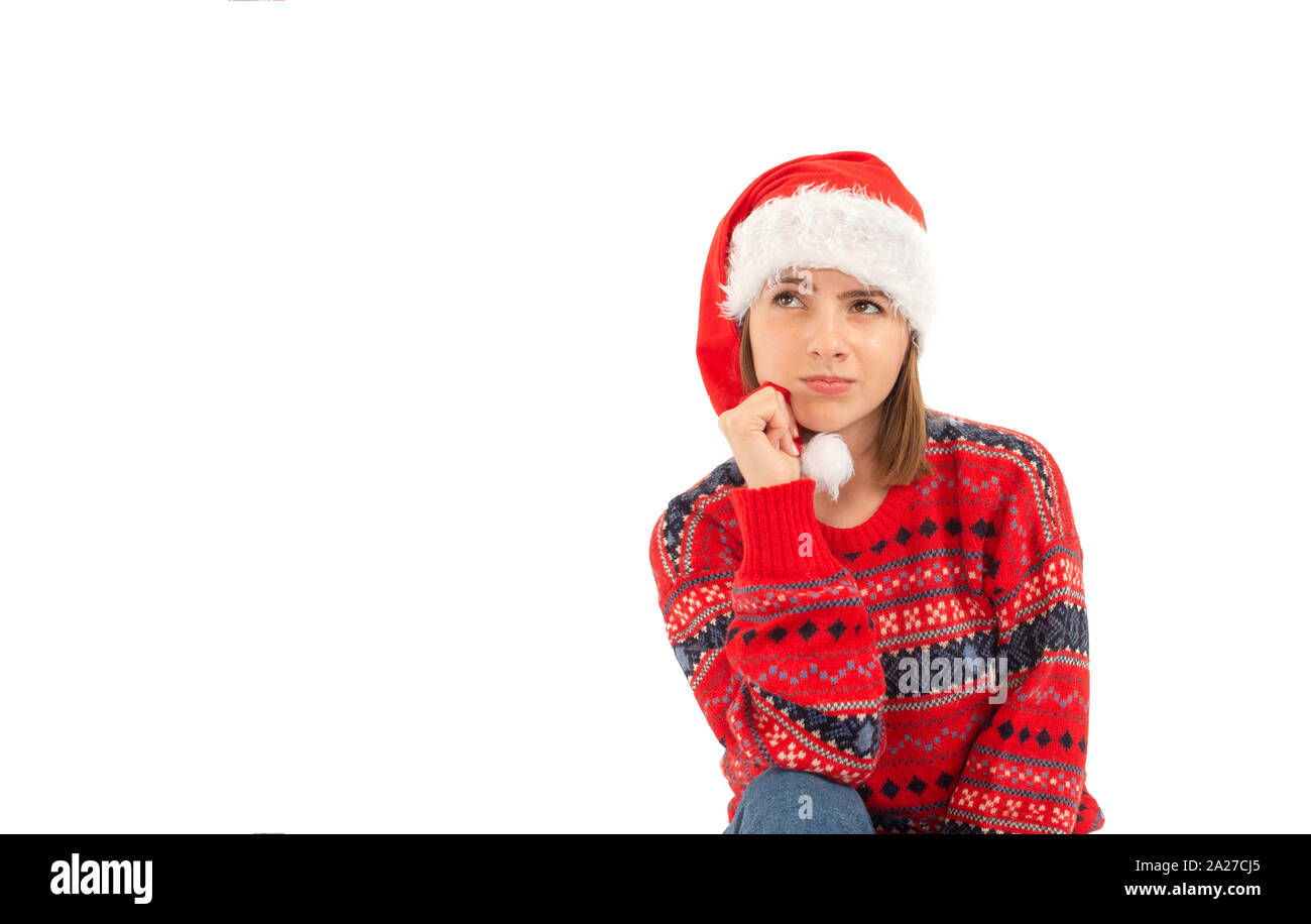 Girl with Santa hat dreaming about her present Stock Photo