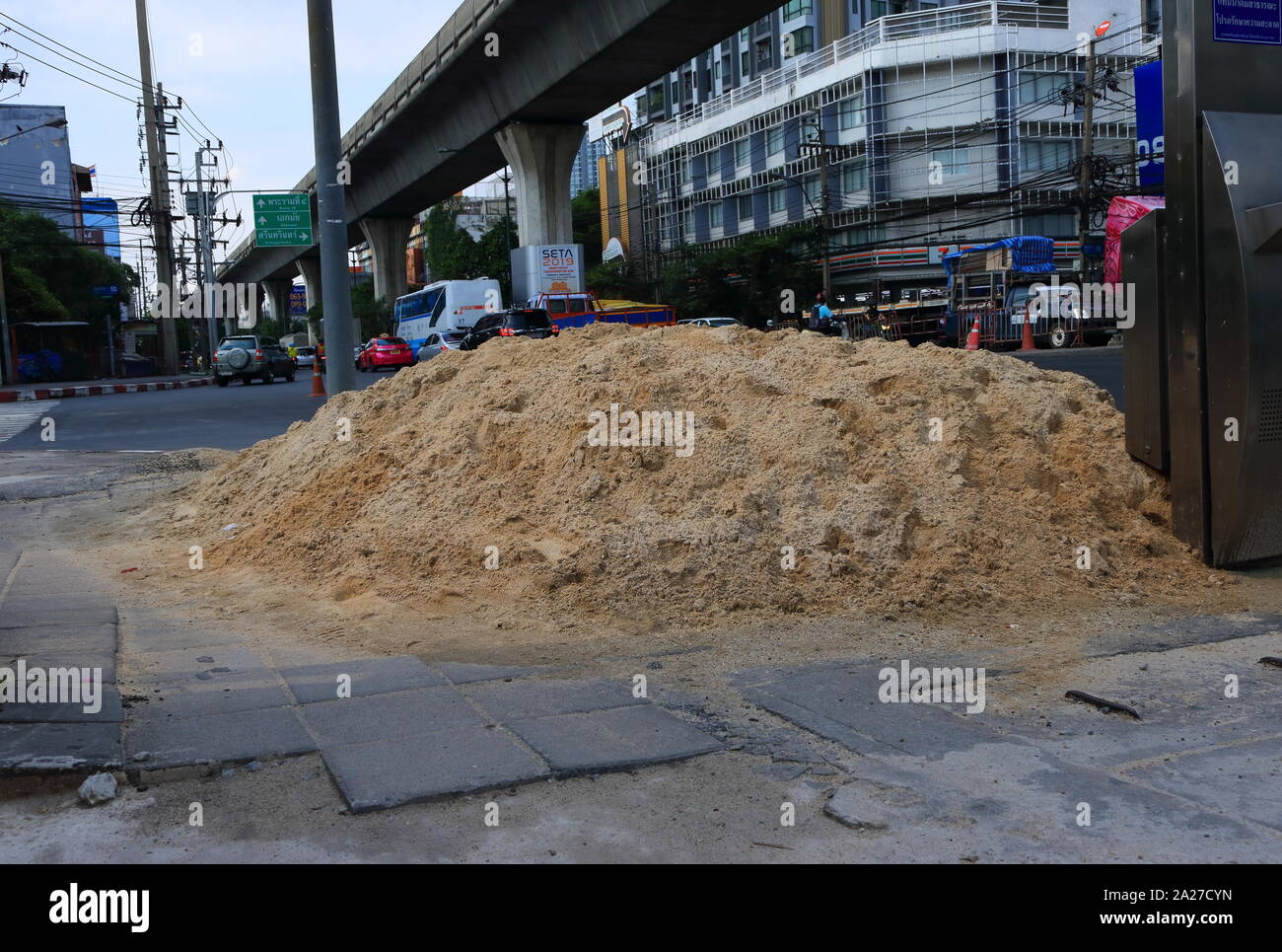 Bangkok, Thailand - September 24, 2019 : Closeup pile of sand on footpath prepared for repairing work Stock Photo