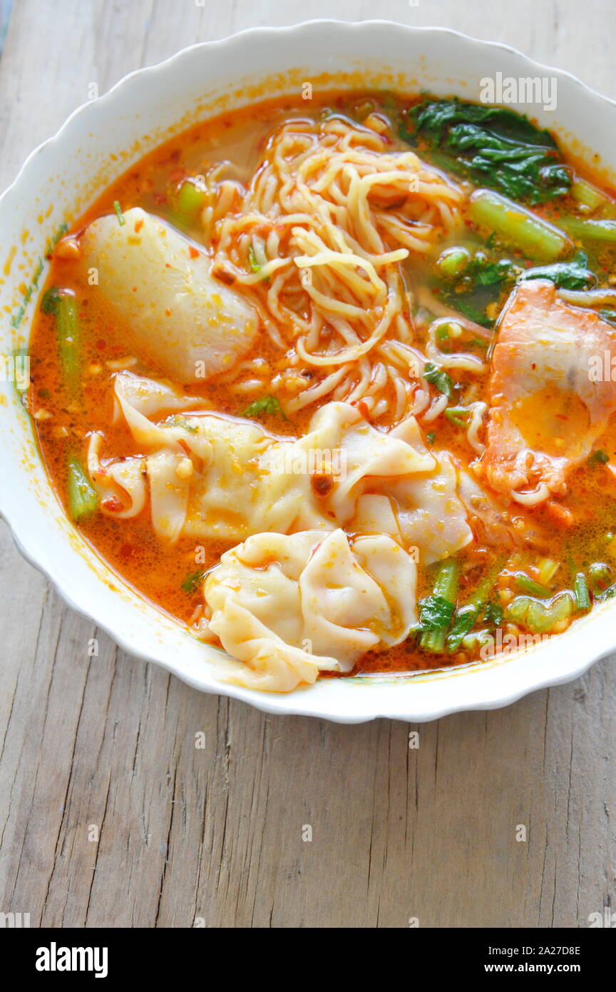 egg noodle with pork dumpling in tom yum soup on bowl Stock Photo Alamy