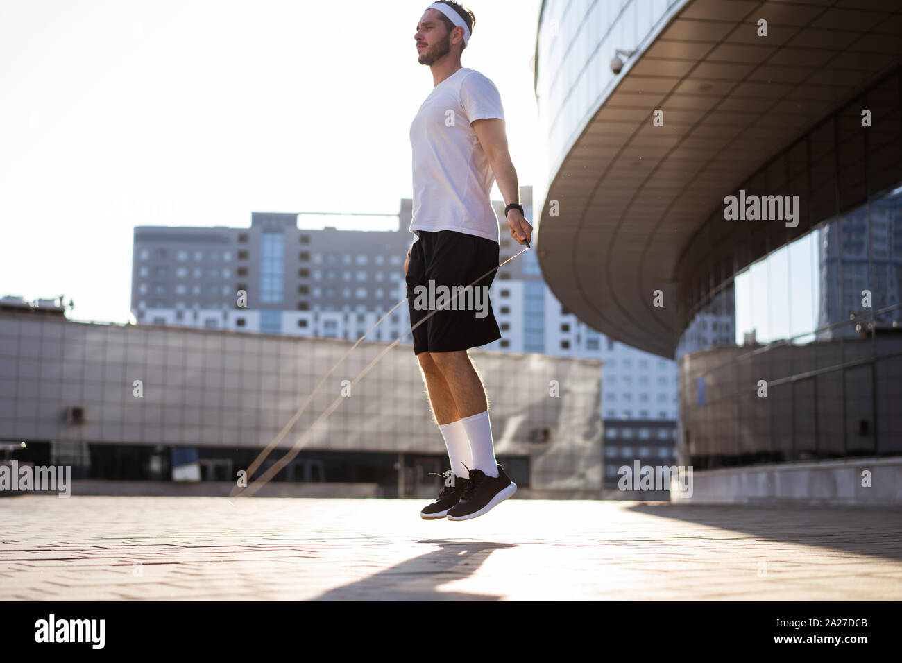 Man Using Jump Rope Model Handsome sportsman jumping rope hi-res stock photography and images - Alamy