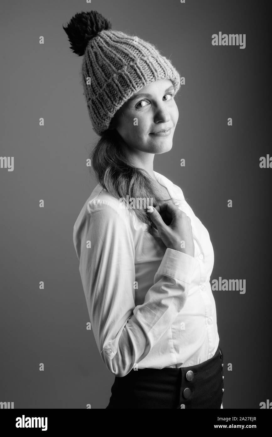 Portrait of young beautiful businesswoman wearing winter beanie hat Stock Photo