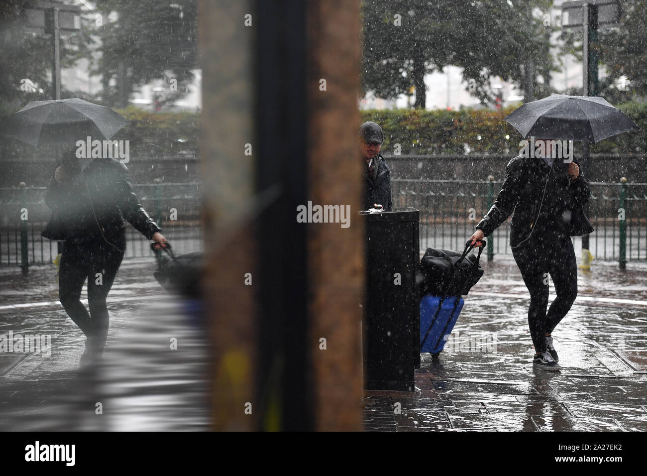People make their way through a heavy rain shower in Birmingham, Tuesday 1st October 2019. See PA story WEATHER Autumn. Photo credit should read: Jacob King/PA Wire Stock Photo