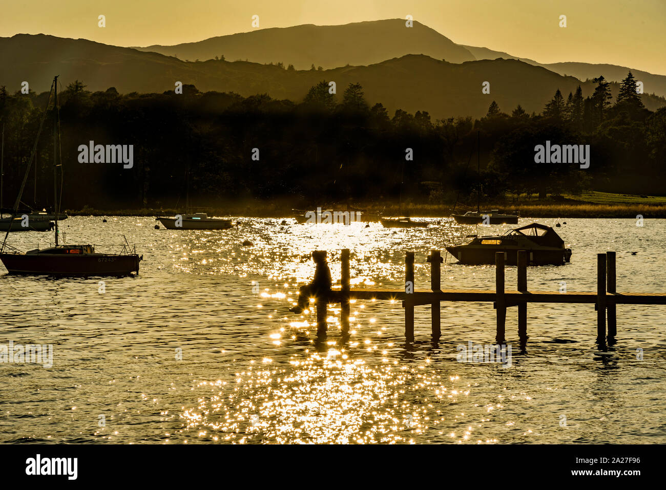 Evening sunshine on Lake Windermere at Ambleside pier. Stock Photo