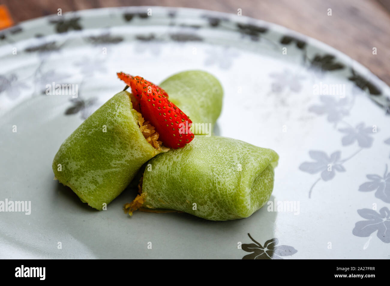Dadar gulung, sweet coconut pancake filled with grated coconut and palm sugar. Traditional Indonesian snack Stock Photo