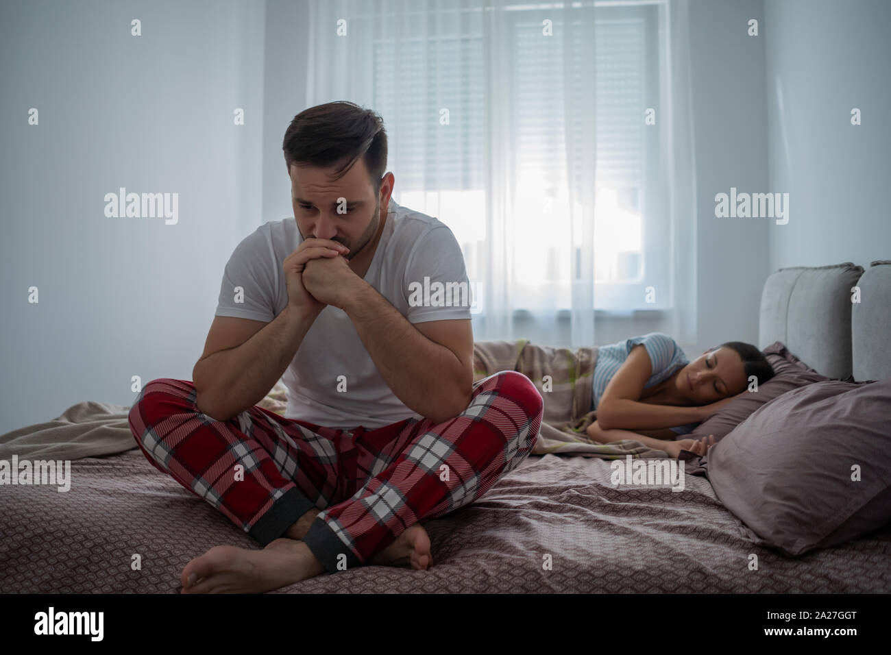 Young man is having trouble with sleep. Stock Photo