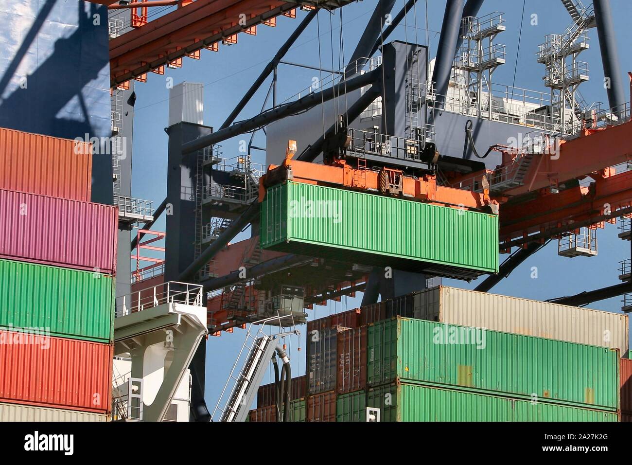 Loading containers on a ship Stock Photo - Alamy