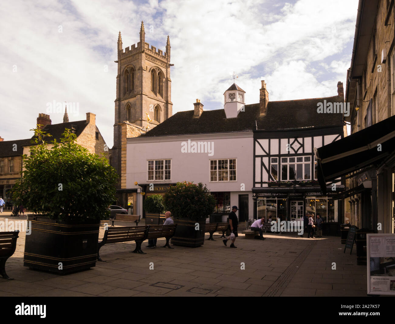 Pedestrianised area of Red Lion Square with a view of the tower of St Michael's Church in the centre of historic town centre Stamford Lincolnshire Eas Stock Photo