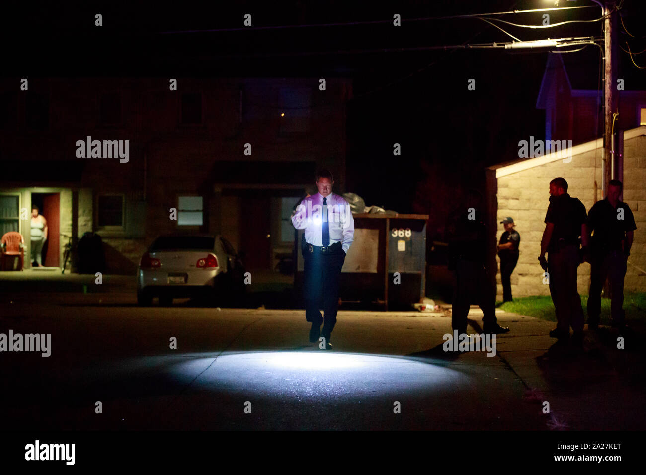 Members of the Bloomington Police Department and the Monroe County Sheriff's Office investigate after a shooting in the 1300 block of West 13th Street, Monday, September 2, 2019 in Bloomington, Ind. The shooting was shortly before 10 p.m. According to Bloomington Police Dept. Lt. Lucas Tate officers were called to the area during a disturbance and reports of shots fired, and as the police arrived officers also reported shots fired. Upon arrival police located 2 gun shot victims; a male was shot in the leg, and a female was shot in the foot. The gunshot wounds were not life threatening and both Stock Photo