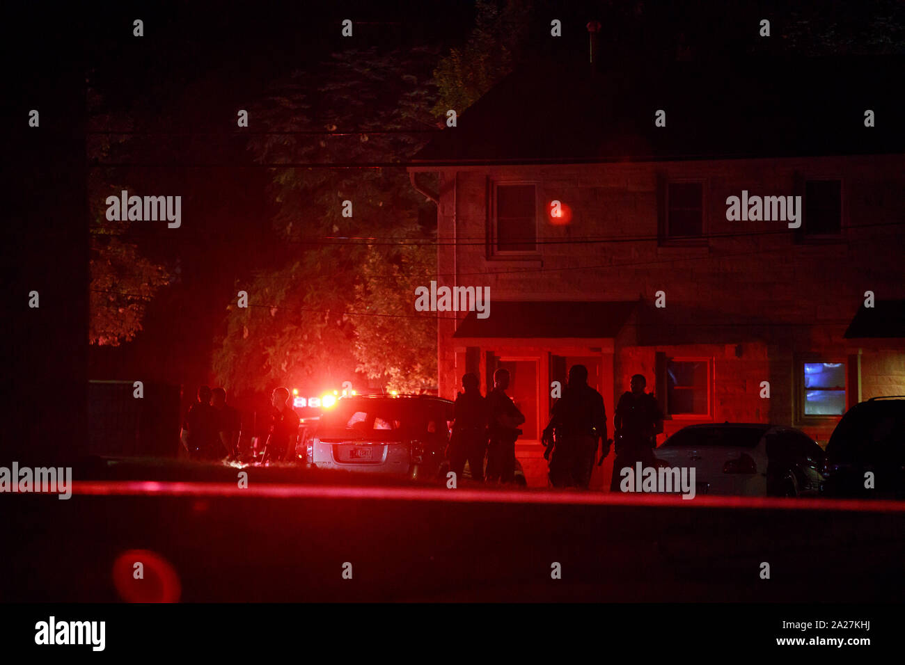 Members of the Bloomington Police Department and the Monroe County Sheriff's Office investigate after a shooting in the 1300 block of West 13th Street, Monday, September 2, 2019 in Bloomington, Ind. The shooting was shortly before 10 p.m. According to Bloomington Police Dept. Lt. Lucas Tate officers were called to the area during a disturbance and reports of shots fired, and as the police arrived officers also reported shots fired. Upon arrival police located 2 gun shot victims; a male was shot in the leg, and a female was shot in the foot. The gunshot wounds were not life threatening and both Stock Photo