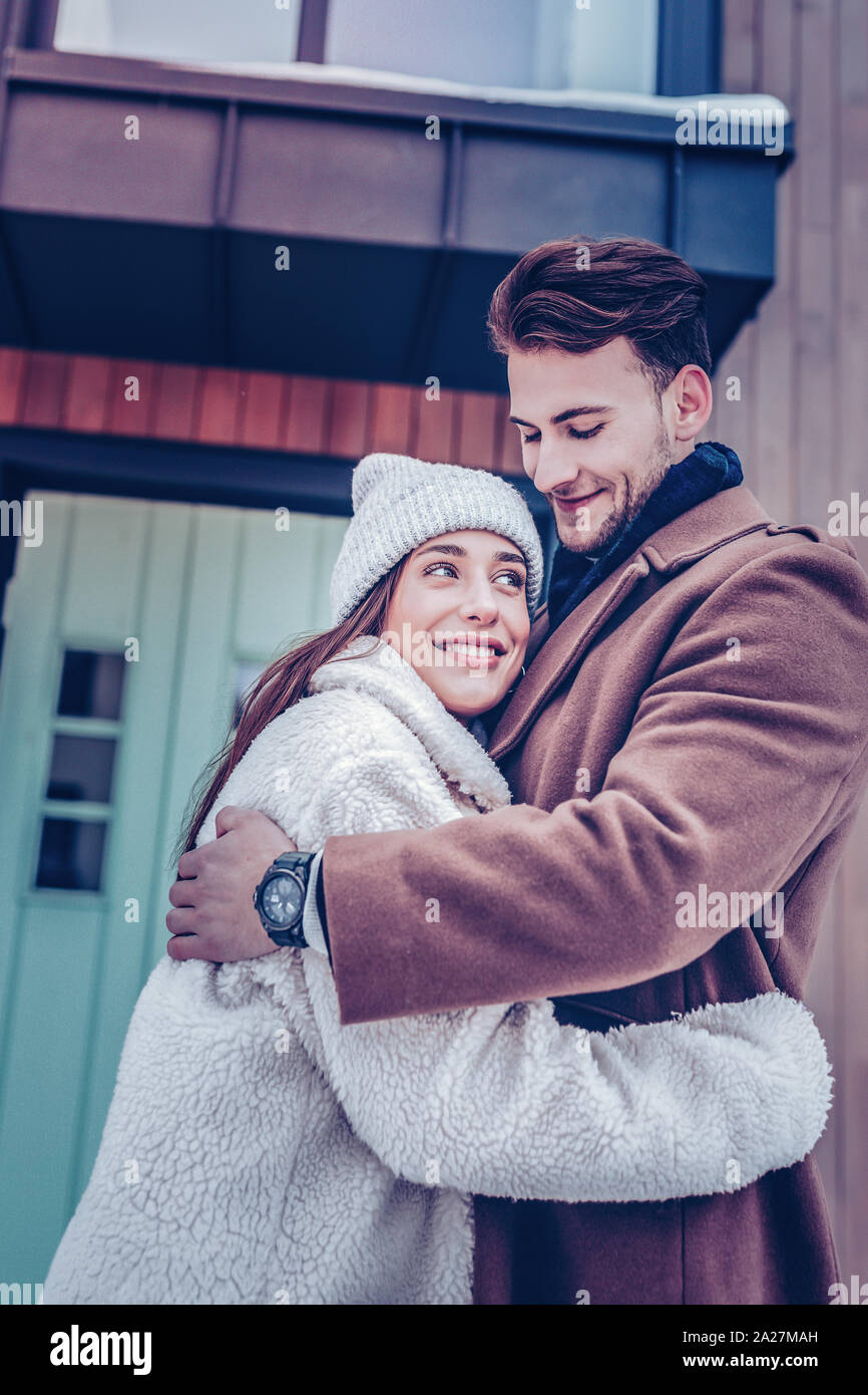 Happy young woman smiling hugging her man during their walk Stock Photo ...