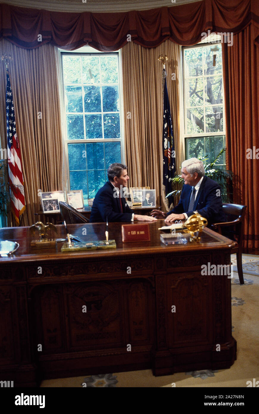 President Ronald Reagan talks to Republican Senators at his desk in the ...