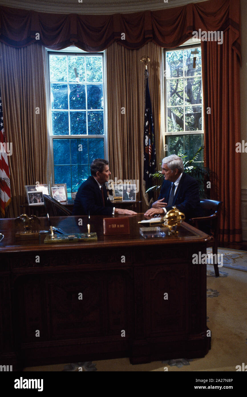 President Ronald Reagan talks to Republican Senators at his desk in the ...