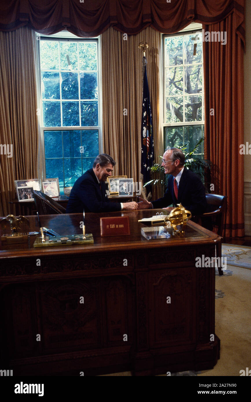 President Ronald Reagan talks to Republican Senators at his desk in the ...