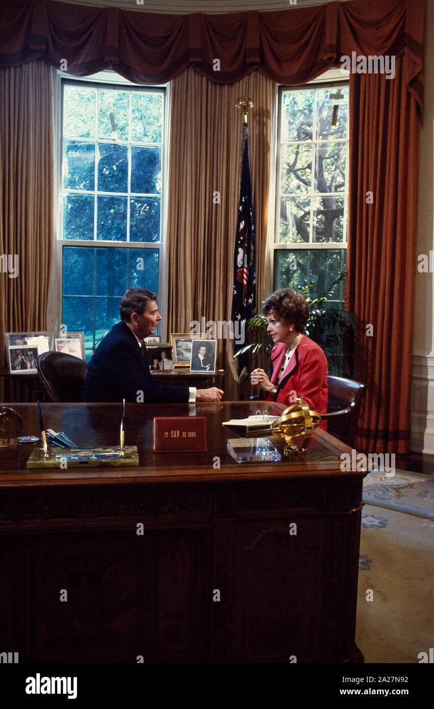 President Ronald Reagan talks to Republican Senators at his desk in the ...