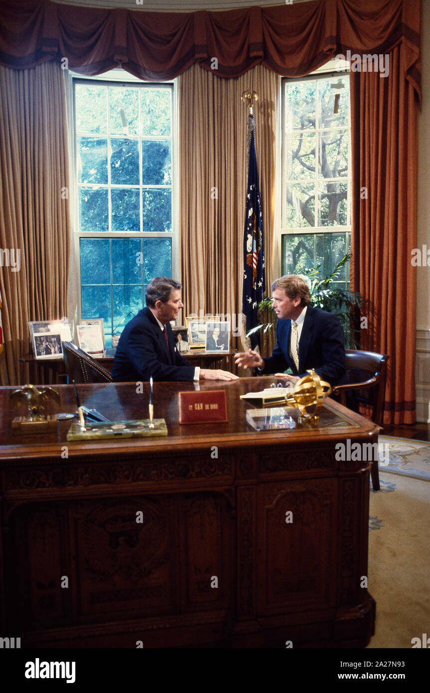 President Ronald Reagan talks to Republican Senators at his desk in the ...