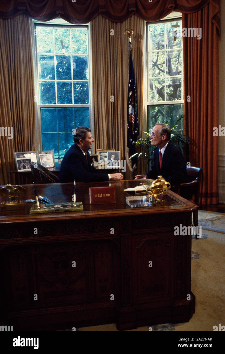 President Ronald Reagan talks to Republican Senators at his desk in the ...