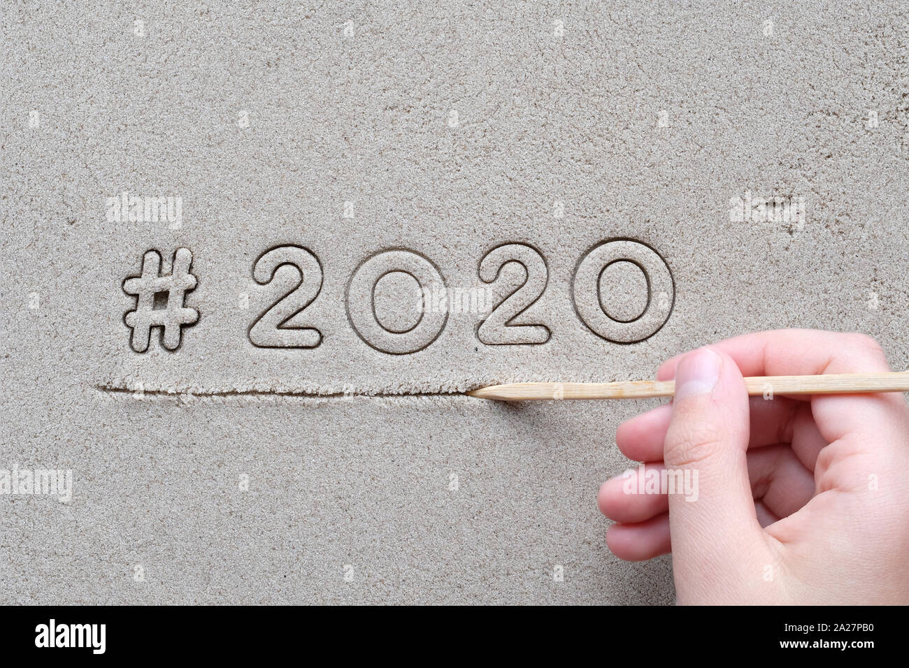 Childs Hand Drawing Hashtag Sign And Number 2020 On Wet