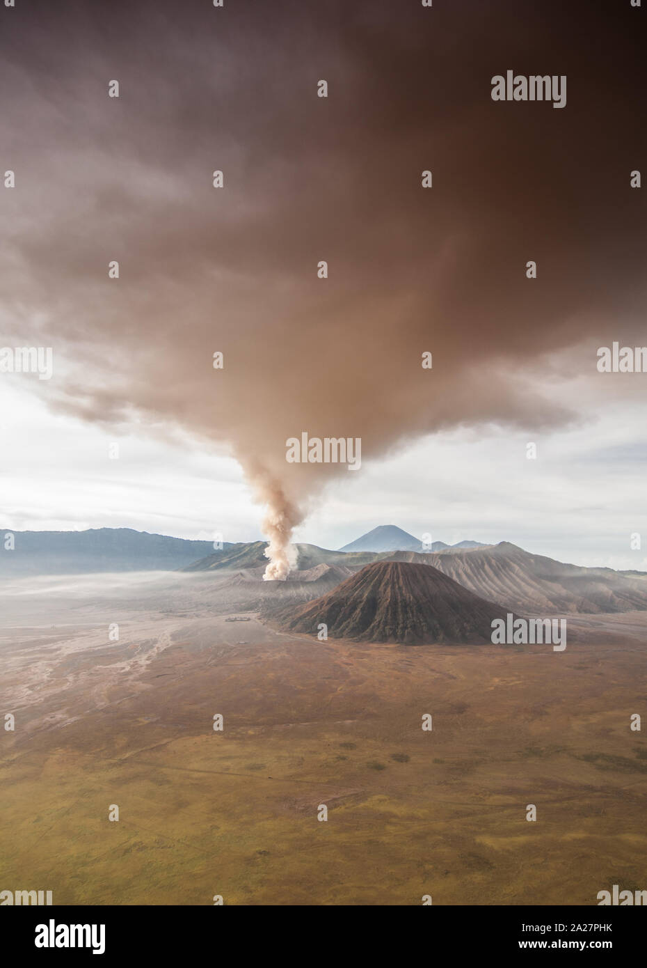 The eruption of mount Bromo darken the surrounding sky. Stock Photo