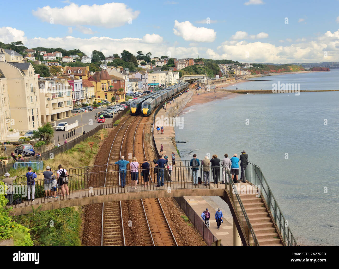Great Western Intercity Express trains passing at Dawlish, South Devon, watched by people on a footbridge. Stock Photo