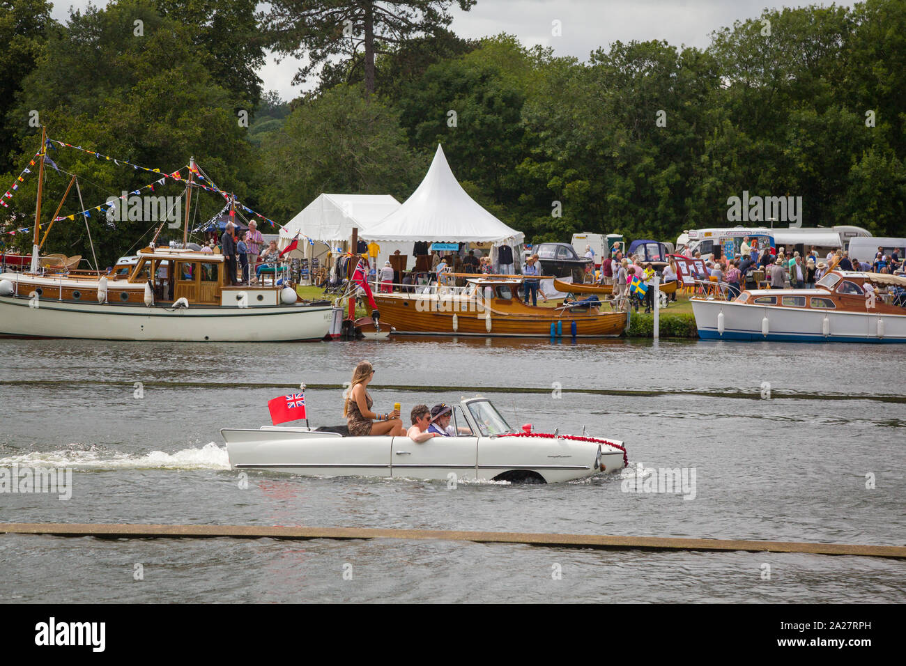 An American Amphicar 770 amphibious car passes the Traditional Thames Boat Rally 2019 at Henley-on-Thames Stock Photo