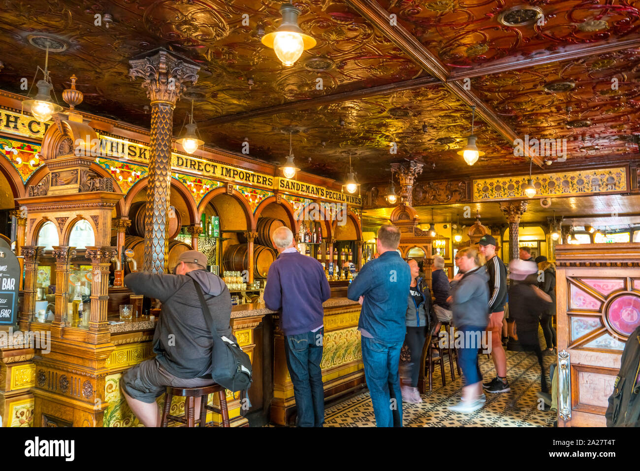 People wait to be served inside the landmark Crown Bar in downtown Belfast, Northern Ireland, United Kingdom Stock Photo