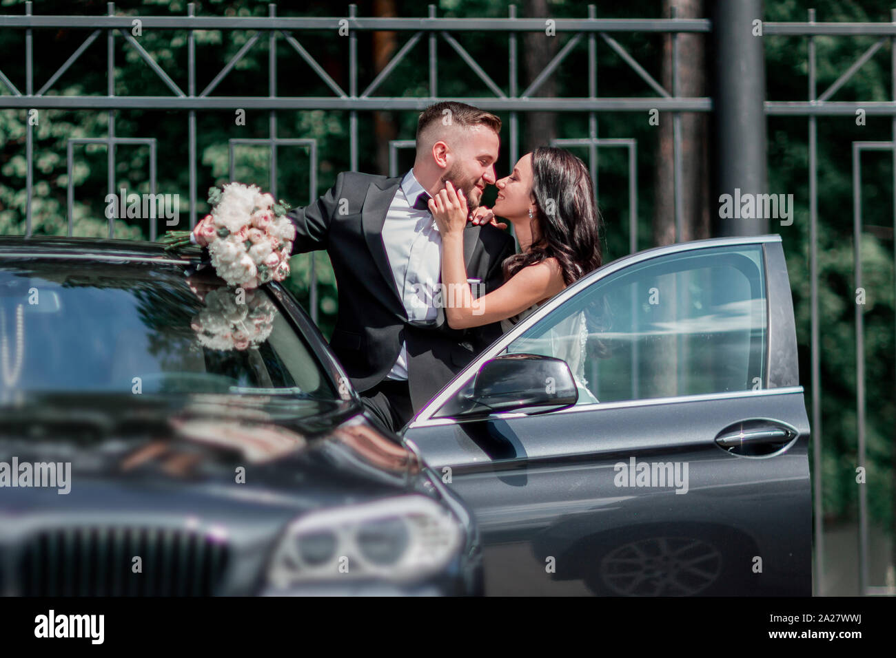 close up. bride and groom standing near the car Stock Photo - Alamy
