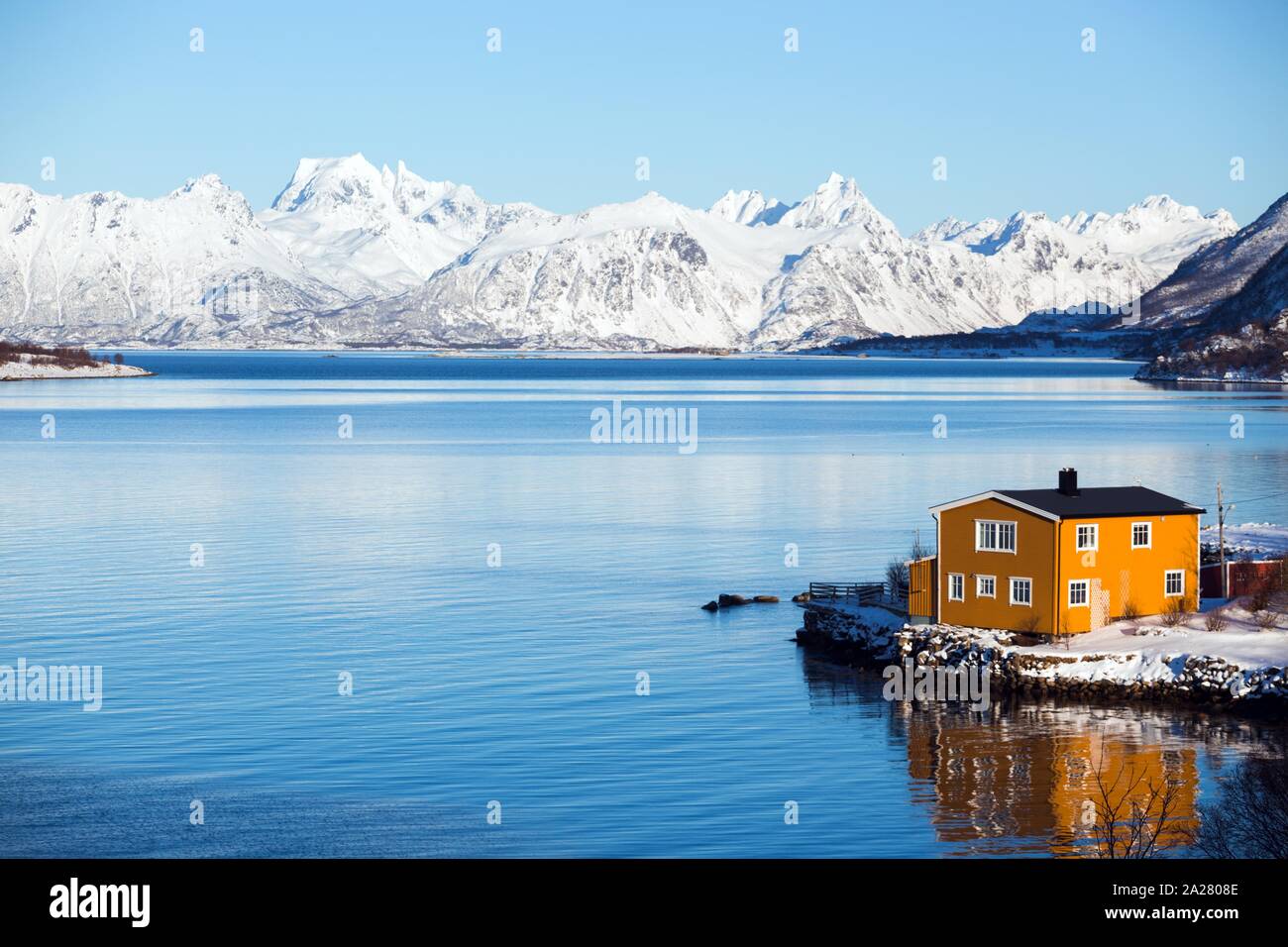 traditional norwegian yellow wooden house to stand at the lakeside and