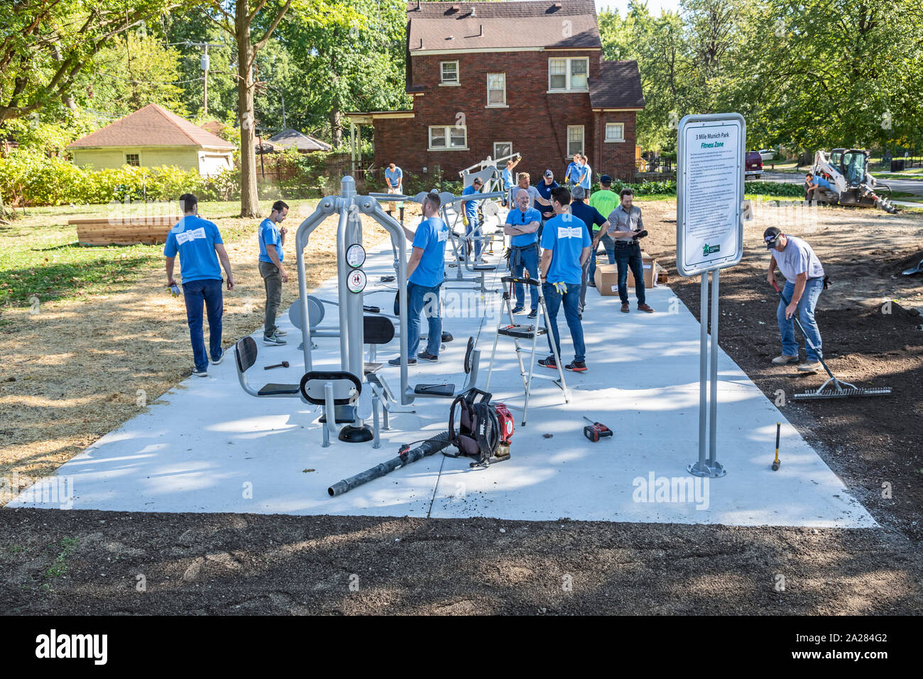 Detroit, Michigan - Volunteers from Cooper Standard install exercise equipment in a new community park in the Morningside neighborhood. Stock Photo